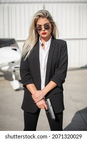 Beautiful Professional Female Spy Agent Bodyguard Posing With Gun. Security Police Woman In Civilian Black Suit. Close Security Protection