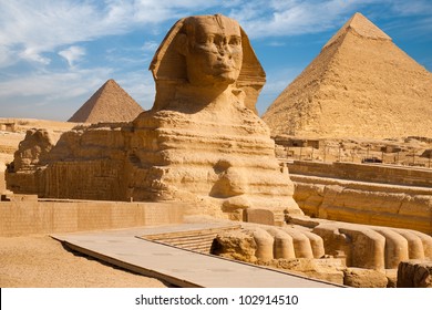 Beautiful profile of the Great Sphinx including pyramids of Menkaure and Khafre in the background on a clear sunny, blue sky day in Giza, Cairo, Egypt