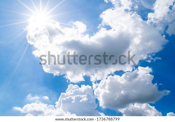 Beautiful Puffy Clouds and Bright Sun in Sky
(Background: Sun Rays and White Clouds)
