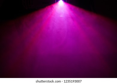 Beautiful Purple Color Wide Lens Projector With Light Beam For Movie And Cinema At Night . Smoke Texture Spotlight . Effects Screening For Multimedia . Black Background .