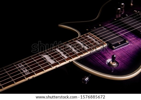 Beautiful purple electric guitar with dark background