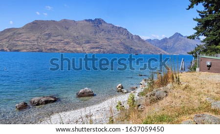 Beautiful Queenstown Hill walking track Sunshine Bay track hiking on sunny summer day to submit gorgeous blue turquoise Wakatipu lake Remarkable mountain range in Queenstown South Island New Zealand 