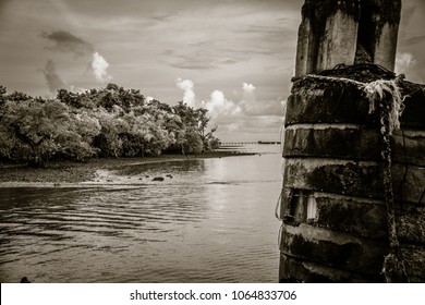 Beautiful Quite Beach In Thailand With Stones In Foreground Taken As Noir Photography.