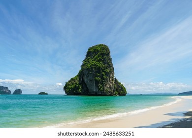 The beautiful Railay Beach and Krabi, Thailand. Railay Beach Krabi Thailand, the tropical beach of Railay Krabi, Panoramic view of idyllic Railay Beach with a traditional long boat and a cloudy sky - Powered by Shutterstock