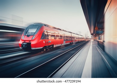 Beautiful Railway Station With Modern High Speed Red Commuter Train With Motion Blur Effect At Sunset. Railroad. Vintage Toning. Railroad Travel Background, Tourism. Industrial