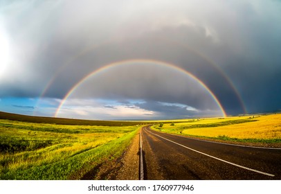 Beautiful Rainbow After Rain Over Spring Road Horizon