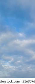 Beautiful Rainy White Clouds On Deep Blue Sky Background. Elegant Blue Sky Picture In Daylight. Big Soft White Fluffy Clouds In The Blue Sky Background. Cumulus Clouds. No Focus