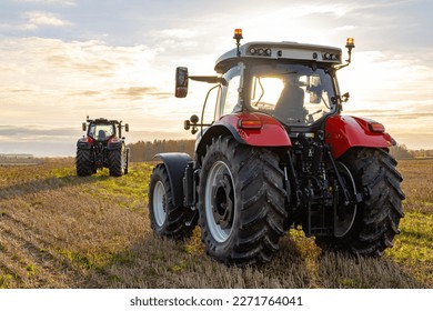 Beautiful Red Big Tractor Parked on the Field in the Shiny Day. Close up of View Background.