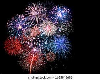Beautiful red and blue fireworks display lights up the sky during night time celebration 