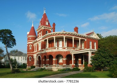 Beautiful Red Brick Queen Anne Home Towers In The Early Morning Light.