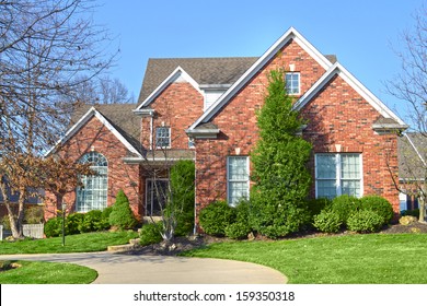Beautiful Red Brick Suburban American Home with driveway