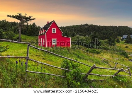 Beautiful red cottage in Tors Cove during sunset , Newfoundland, Canada
