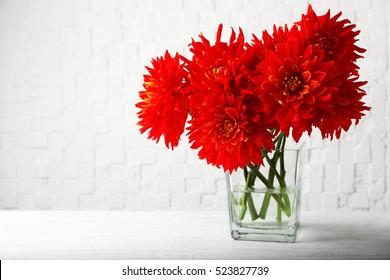 Beautiful Red Dahlia Flowers In Vase On Light Background