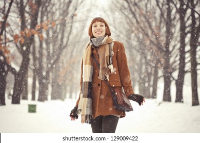 Beautiful Red Hair Girl In Winter Park With Snow