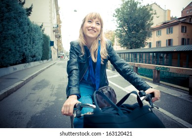 Beautiful Red Head Woman On Bike In The City