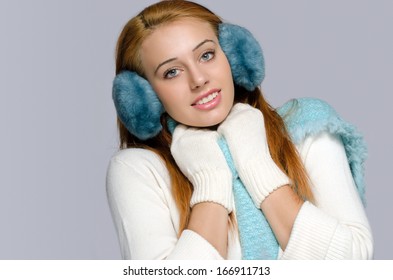  Beautiful Red Head Woman Wearing Blue Ear Muffs Trying To Get Wormed 