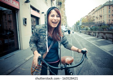 Beautiful Red Head Womanon Bike In The City