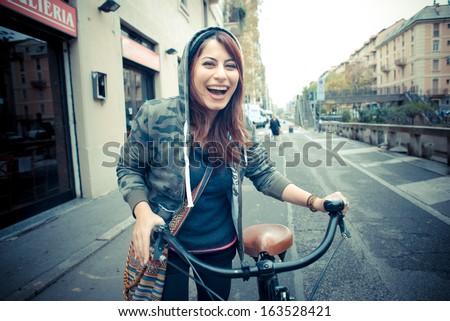 beautiful red head womanon bike in the city