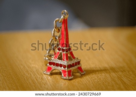 A beautiful red key chain Eiffel tower .