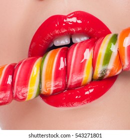 Beautiful red lips with candy.