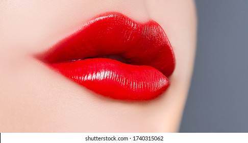 Beautiful Red Lips Close-up. Classic Red Lips With Sexy Smirk. Textured Lips With Gloss Red Lipstick. Passionate Red Lips