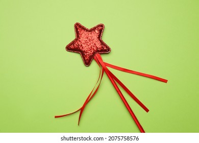 Beautiful Red Magic Wand On Light Green Background, Top View