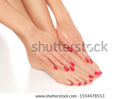 Beautiful red manicure and pedicure isolated on white background.