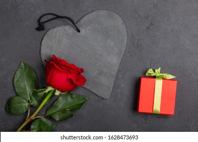 Beautiful Red Rose Flower And Gift Box On A Black Background. Top View, Flatlay, Copy Space.