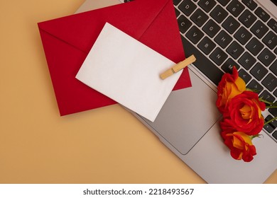 Beautiful Red Roses Flowers In Postal Red Envelope On Neutral Beige Background, Laptop Keyboard Technology Online Empty Paper Note Copy Space For Text, Spring Time, Greeting Card For Holiday. Flower