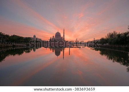 Beautiful red sky during sunrise with lake reflection at Putrajaya Lake Garden.  Motion Blur, Soft Focus due to Slow Shutter Speed. Copy Space Area.