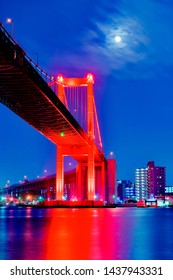 The beautiful red suspension bridge which is lighted up by the moon
