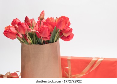 Beautiful red tulips in a gift bag and gift boxes. Congratulatory photo happy birthday, March 8, Mother's Day. Place for text - Powered by Shutterstock