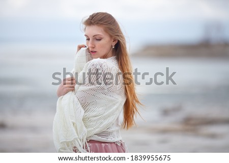 beautiful red-haired girl in a pink dress walks on the seashore, fabulous photo session