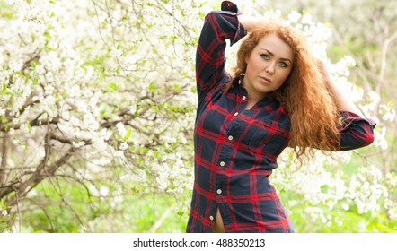 Beautiful Red-haired Woman With Freckles And Spring Cherry Blossoms