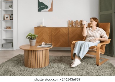 Beautiful redhead woman with cute rats sitting in armchair at home - Powered by Shutterstock