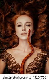 Beautiful Redhead Woman With Orange Snake