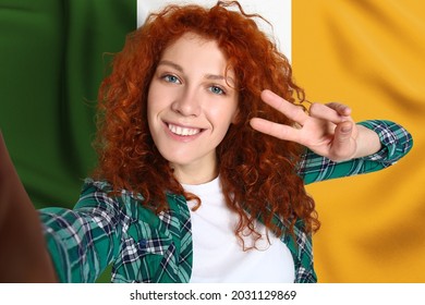 Beautiful Redhead Woman Taking Selfie Against Irish Flag