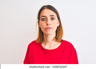 Beautiful redhead woman wearing casual red t-shirt over isolated background Relaxed with serious expression on face. Simple and natural looking at the camera. - Shutterstock ID 1558762247