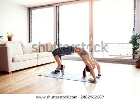 Similar – Image, Stock Photo young caucasian woman doing fitness on mat at home