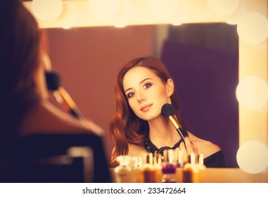 Beautiful Redhead Women Applying Makeup Near Mirror