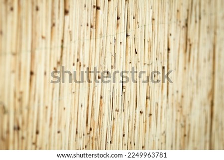 Beautiful reed fence wall on pyrode background