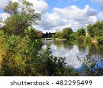 Beautiful reflection, of clouds and blue sky, reflect from the still waters of the Yahara River in Stoughton, Wisconsin.