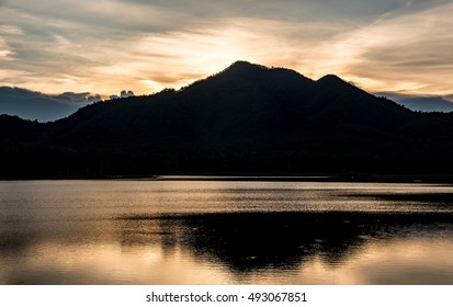 beautiful reflection of sky mountain and cloud on lake surface in evening time 