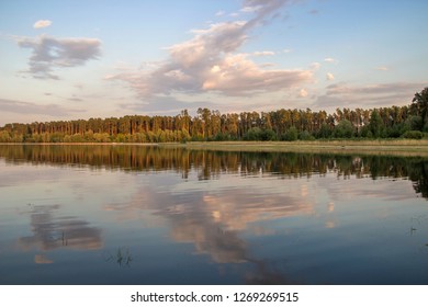 Beautiful reflection of a sunset cloud over a lake in the forest.