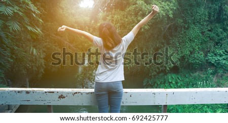 beautiful Refreshed woman in the forests And warm light