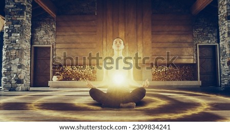 Beautiful Relaxed Caucasian Woman In Lotus Position Meditating In Zenlike Openair Space. Edited Visualization Of Bright Energy Accumulating In Her Stomach. Yoga Practice, Spirituality, And Mindfulness