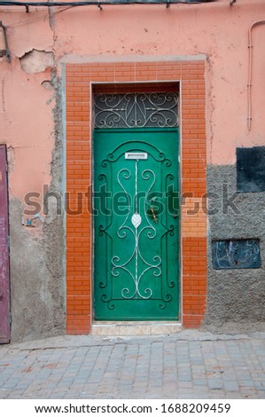 Beautiful residential iron door, with beautiful design, white details, in the Medina, Morocco