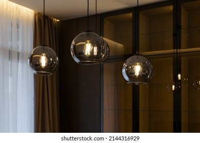 Beautiful retro luxury interior lighting lamp decor. Lamp in the interior. Stylish and modern lamp in loft style in the apartment. Premium Photo. Modern lamp chandelier on a black.