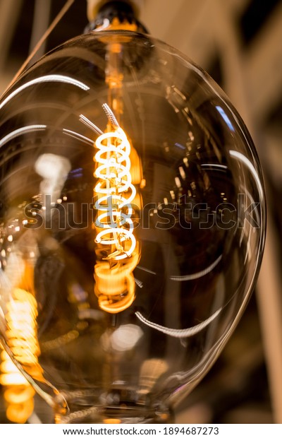 Beautiful retro luxury light lamp decor\
glowing.House interior of loft and rustic style. vintage light bulb\
hanging decor glowing in dark. Blend of history and\
modern.incandescent Edison type\
bulbs