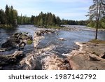 Beautiful river scenery with cliffs, forest and rapids. The photo is taken in recreational area of Koiteli in Oulu, Finland.
